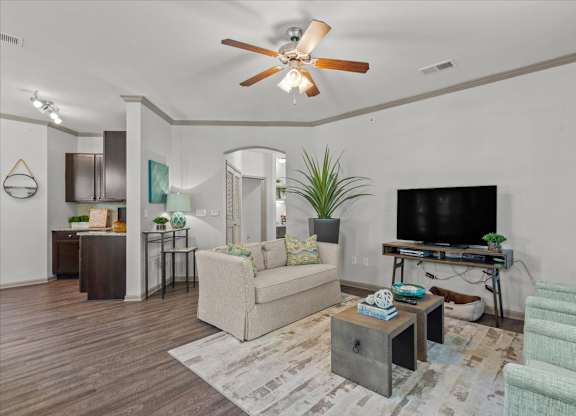 a living room with white walls and a ceiling fan at Stonepost Crossing Apartments, Overland Park, KS