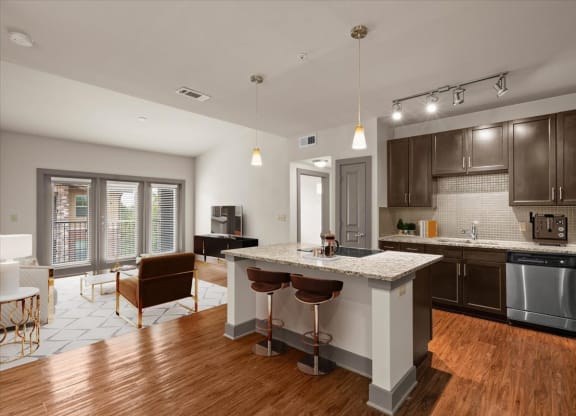 an open kitchen and living room with a large island