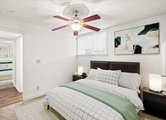 a bedroom with a bed and a ceiling fan at Fiesta Square Apartments & Townhomes, Overland Park, KS