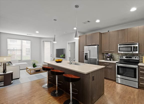 a large kitchen with a center island with three stools