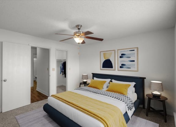 a bedroom with a bed and a ceiling fan