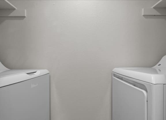 a white washer and dryer in a white room at Highland Park Apartment Homes, Kansas, 66214
