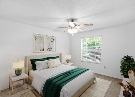 a bedroom with a bed and a ceiling fanat Stonebriar Apartments, Overland Park, Kansas