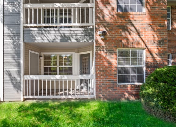 a red brick house with a white porchat Stonebriar Apartments, Kansas, 66213
