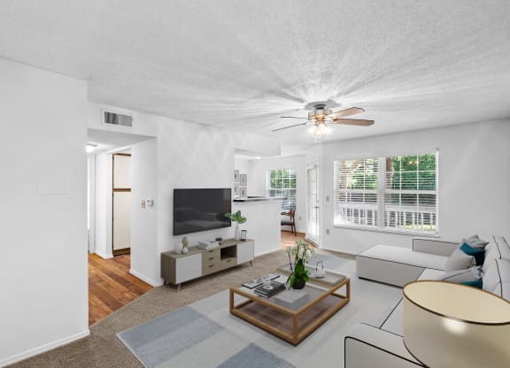 a living room with white walls and a ceiling fanat Stonebriar Apartments, Overland Park, KS