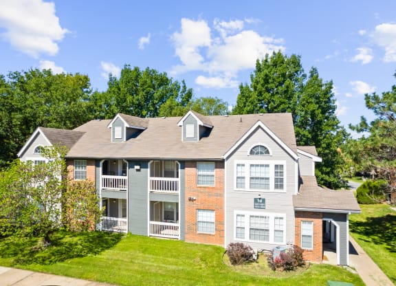 a house on a hill with trees in the backgroundat Stonebriar Apartments, Overland Park, Kansas