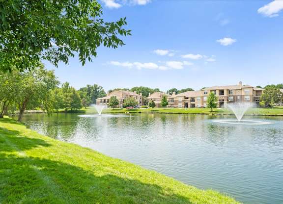 A serene lake with a fountain at Stonepost Lakeside Apartment Homes, Kansas, 66062