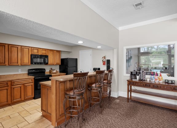 a kitchen with a large island and a breakfast bar at Millcreek Woods Apartments, Olathe, Kansas