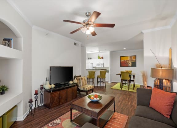 a living room with a couch and a table in front of a tv