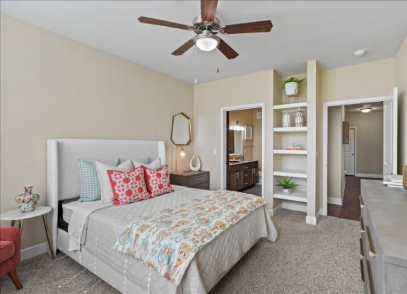 a bedroom with a bed and a ceiling fan at The Residences at Bluhawk Apartments, Kansas