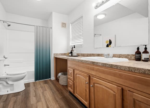 a bathroom with a toilet sink and shower
