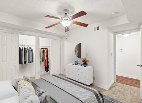a bedroom with a bed and a ceiling fan at Fiesta Square Apartments & Townhomes, Overland Park