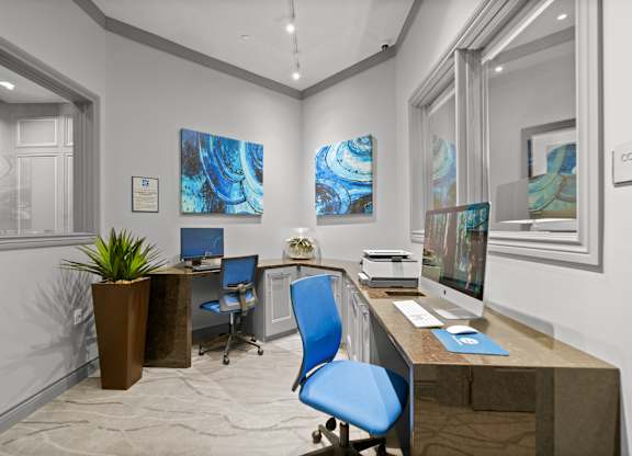 A modern office with a blue chair and a brown desk.