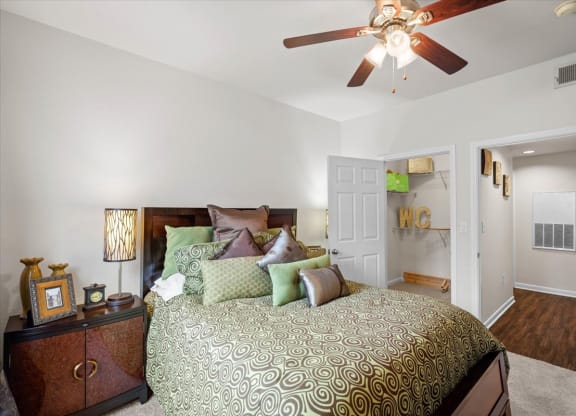 a bedroom with a bed and a ceiling fan