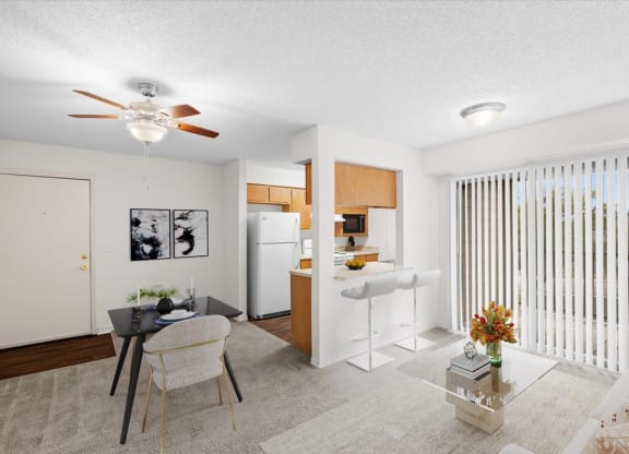 a living room with a kitchen and a ceiling fan at Wind River Lodge, Lenexa, 66219