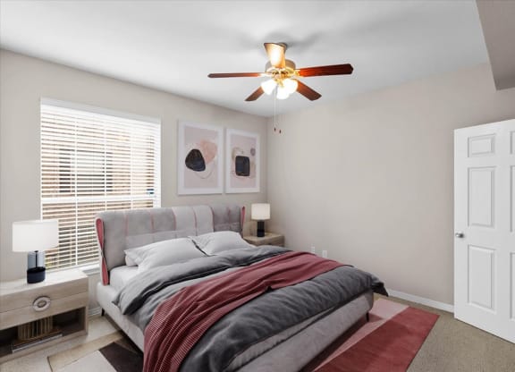 a bedroom with a bed and a ceiling fan at The Clairborne Apartment Homes, Grand Prairie, Texas