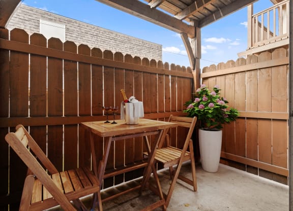 a small patio with a table and two chairs