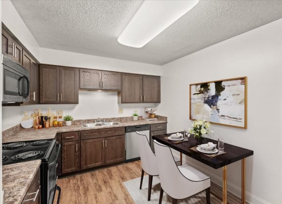 our apartments offer a kitchen and dining area with a table at Fiesta Square Apartments & Townhomes, Overland Park, Kansas