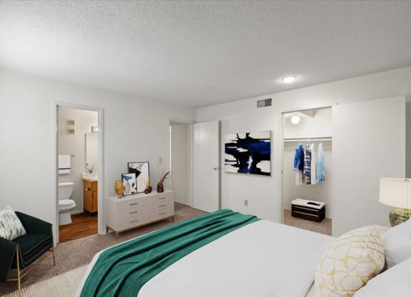 A primary bedroom with a large walk-in closet and an attached bathroom.