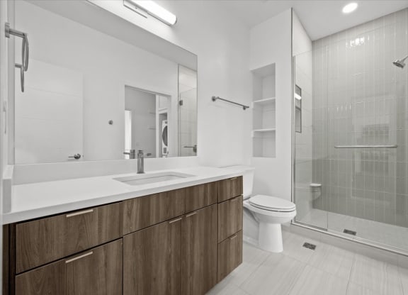a bathroom with a toilet sink and a shower