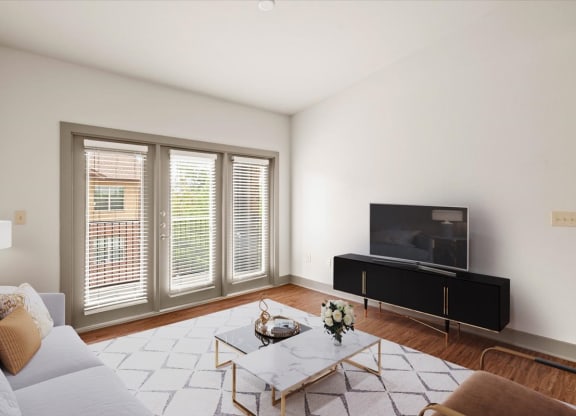 a living room with white walls and hardwood floors