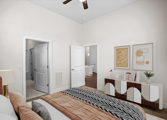 a bedroom with a bed and a door to a bathroom