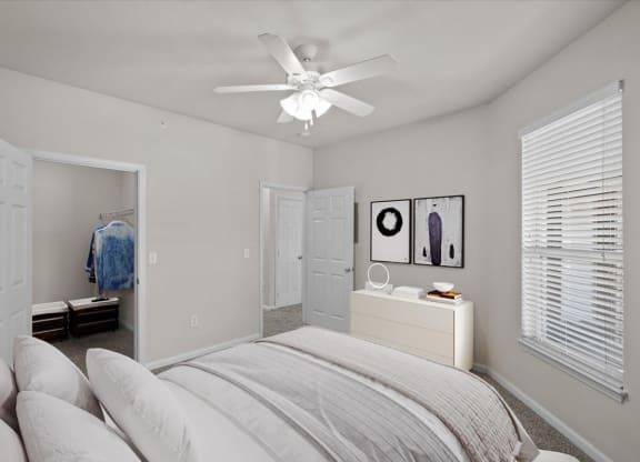 a bedroom with a bed and a ceiling lamp