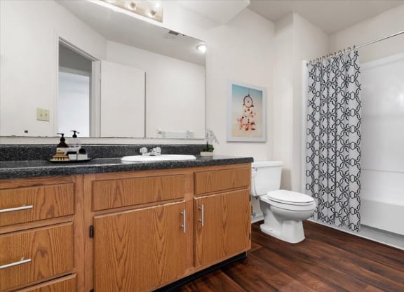 a bathroom with a toilet and a sink at Deerfield Apartments, Olathe, KS, 66062