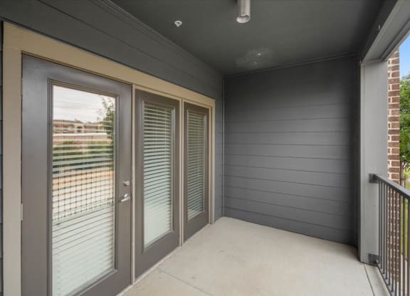 a patio with sliding glass doors and a balcony