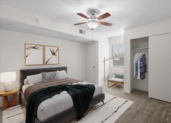 a bedroom with a bed and a ceiling fan at Wind River Lodge, Lenexa, KS
