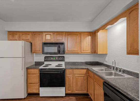 a kitchen with a stove refrigerator and sinkat Millcreek Woods Apartments, Kansas, 66061