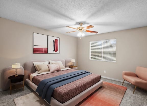 A bedroom with a ceiling fan and window.