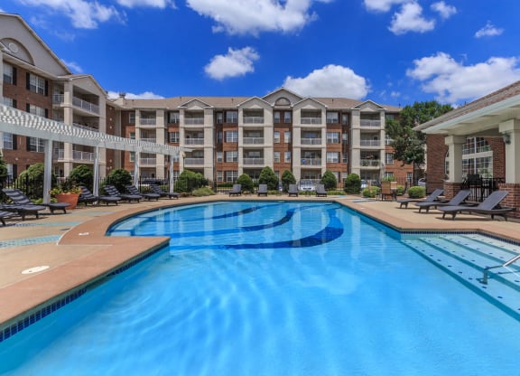 A large outdoor courtyard swimming pool with lounge seating.