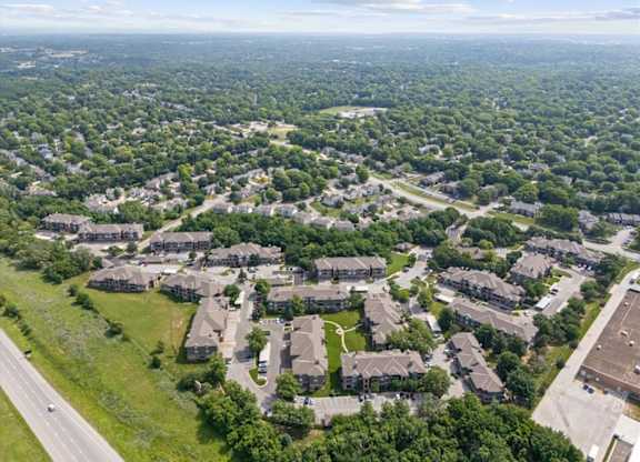 A bird's eye view of a residential area with houses and greenery.