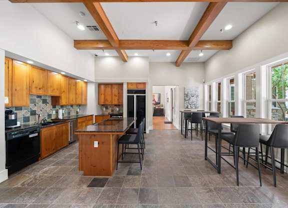 A kitchen with wooden cabinets and a black stove top oven. at Stonepost Lakeside Apartment Homes, Olathe, KS, 66062