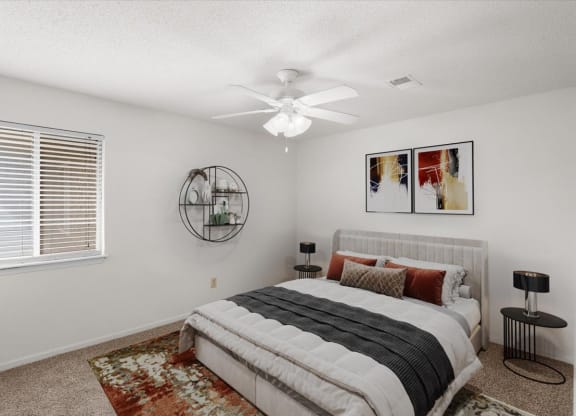 a bedroom with a bed and a ceiling fan at Deerfield Apartments, Olathe, KS
