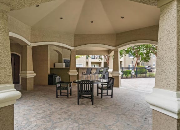 a patio with a table and chairs