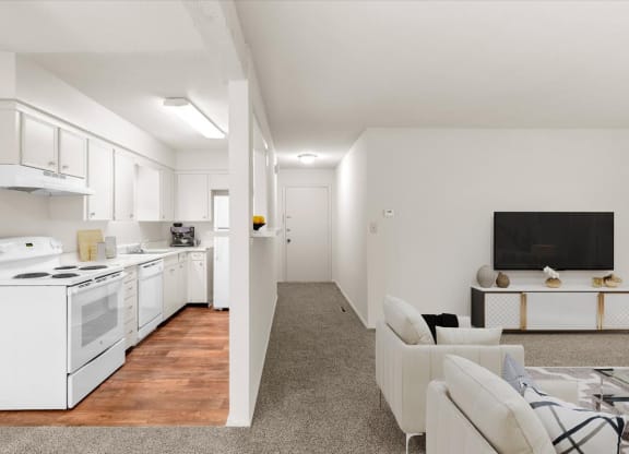 An open layout with a living room, hallway, and kitchen.