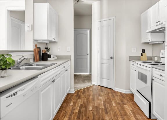 a kitchen with white cabinets and white appliances