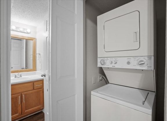 a white washer and dryer in a bathroom at Creekview Apartment Homes, Texas, 75254