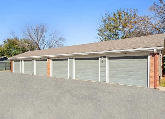 a row of garage doors in front of a house