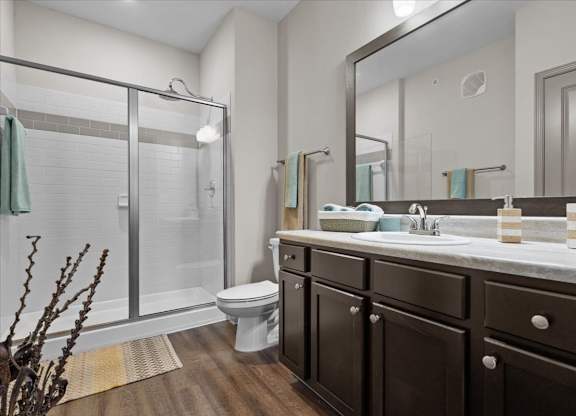 a bathroom with a toilet sink and shower at Stonepost Crossing Apartments, Overland Park, Kansas