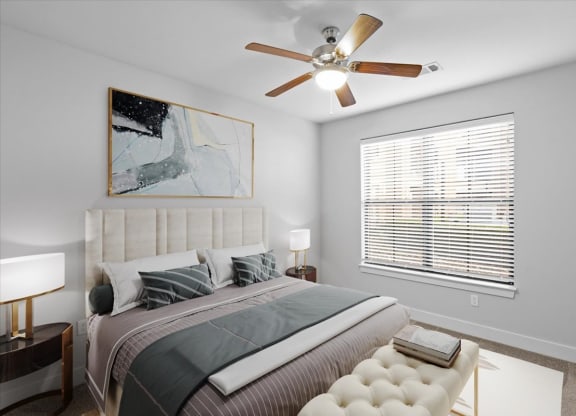 a bedroom with a large bed and a ceiling fan