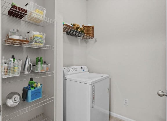 a white washer and dryer in a room with a closet at Stonepost Lakeside, Olathe, Kansas