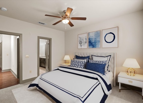 a bedroom with a large bed and a ceiling fan