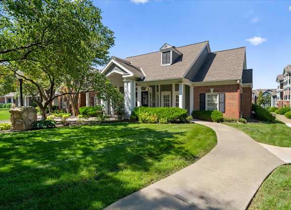 A house with a well-manicured lawn and a stone pathway leading to the front door. at Somerset Oaks Apartment Homes, Kansas