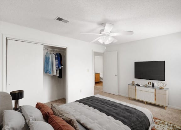 a bedroom with a bed and a ceiling fan at Deerfield Apartments, Kansas