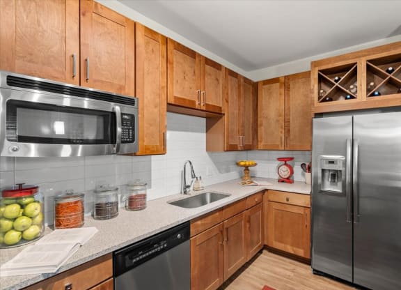 a kitchen with wooden cabinets and stainless steel appliances