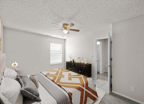 A bedroom with a bed, nightstand, and a ceiling fan.