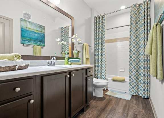 a bathroom with a sink toilet and shower at Stonepost Crossing Apartments, Overland Park, 66213